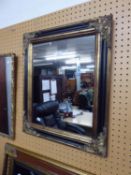 A RECTANGULAR WALL MIRROR, IN BLACK AND GILT FRAME