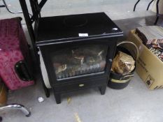 A SMALL DIMPLEX STOVE/FIRE AND A METAL LOG BASKET AND A MODERN GREY PAINTED CIRCULAR MIRROR (3)