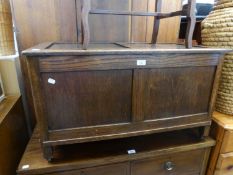 AN OAK AND PLY PANELLED BLANKET CHEST, RAISED ON FEET WITH CASTORS