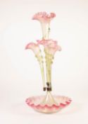 LATE VICTORIAN GREEN TINTED GLASS TABLE EPERGNE, having four trumpet shape pink tinted frilled-