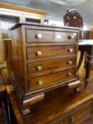 A SMALL REPRODUCTION MAHOGANY FOUR DRAWER CHEST (55cm high x 52cm wide x 34cm deep)