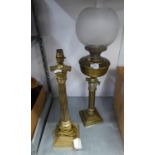 A BRASS CORINTHIAN COLUMN OIL LAMP WITH OPAQUE GLASS GLOBULAR SHADE AND GLASS FUNNEL AND A SIMILAR