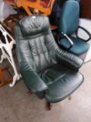 A REVOLVING EASY ARMCHAIR, COVERED IN PANELLED DARK GREEN LEATHER TO THE BACK, ARMS AND SEAT, ON