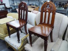 A PAIR OF VICTORIAN ?GOTHIC? CARVED WALNUT HALL CHAIRS