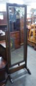 AN OAK CHEVAL ROBING MIRROR, THE FRAME WITH BEADED BANDING