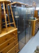 A SET OF THREE PLATE GLASS DISPLAY CABINETS, TALL AND NARROW (3)