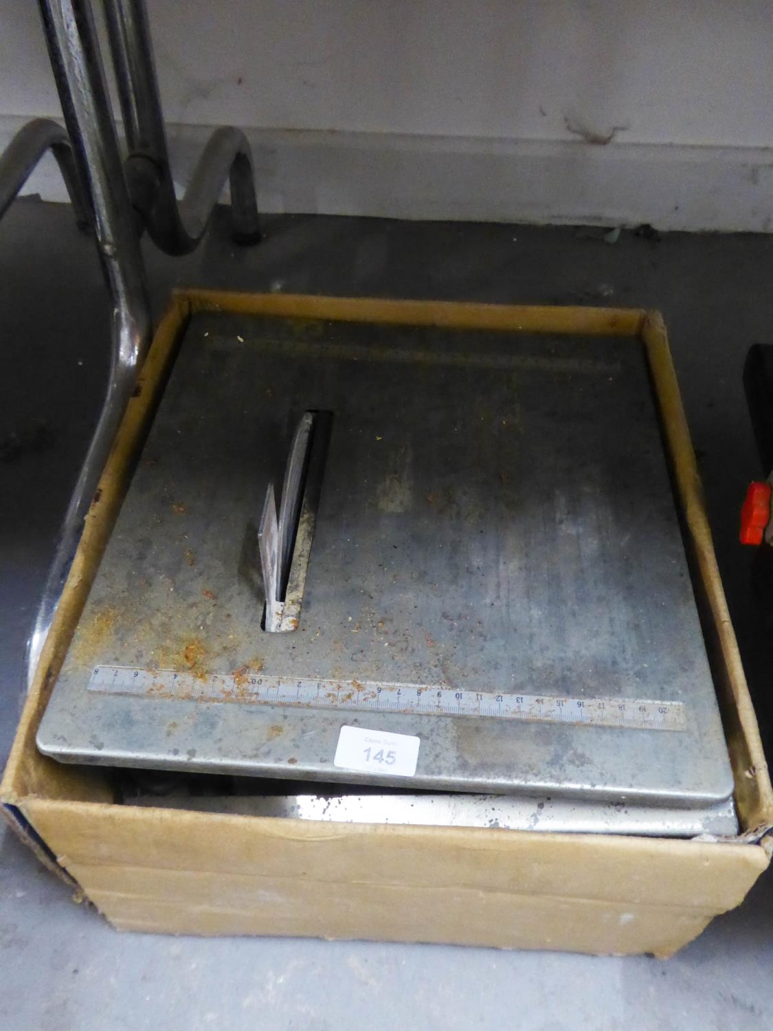AN ELECTRIC  TABLE TOP TILE CUTTER