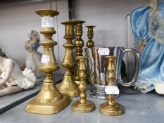 TWO PAIRS OF BRASS CANDLESTICKS, ANOTHER SMALLER PAIR, BRASS LION FACED DOOR KNOCKER, AND A