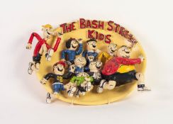 HOWARD GORST (b.1955) PAINTED OVAL CERAMIC PLAQUE, MODELLED IN RELIEF ?The Bash Street Kids? 9? x