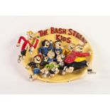 HOWARD GORST (b.1955) PAINTED OVAL CERAMIC PLAQUE, MODELLED IN RELIEF ?The Bash Street Kids? 9? x