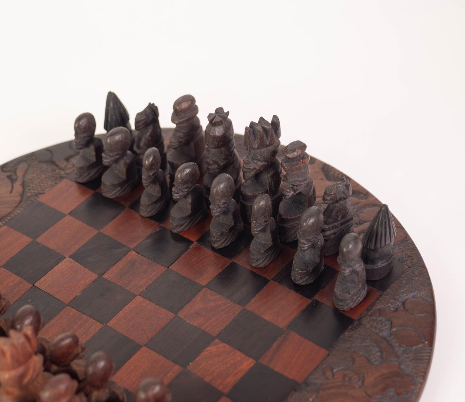 A TWENTIETH CENTURY AFRICAN CIRCULAR CARVED AND CHEQUERED WOODEN CHESS BOARD with dark and lighter - Image 3 of 4