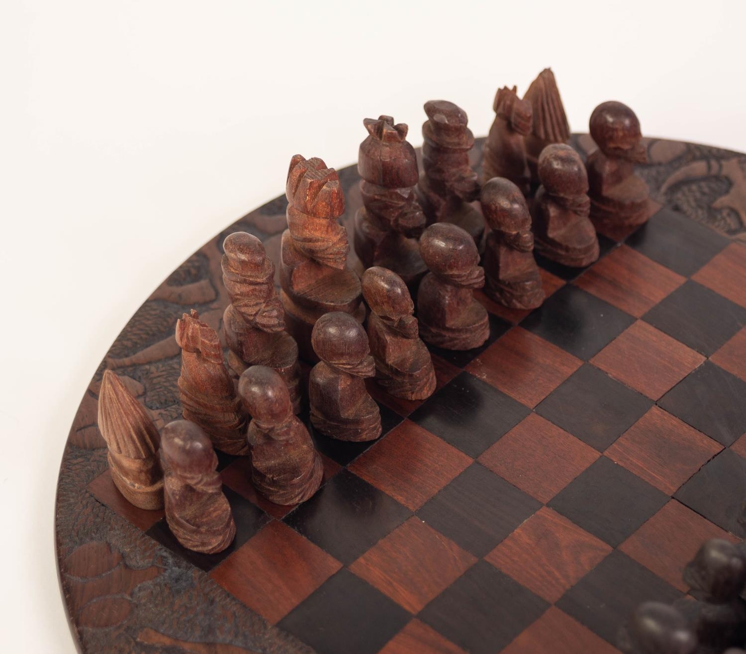 A TWENTIETH CENTURY AFRICAN CIRCULAR CARVED AND CHEQUERED WOODEN CHESS BOARD with dark and lighter - Image 2 of 4