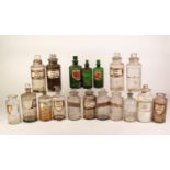 TWELVE CLEAR GLASS DRUG JARS, various sizes, the stoppers with oblong grips/tops, TWO LARGER SIZE