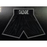 PAIR OF JOE CALZAGHE SIGNED BLACK SILK FABRIC BOXERS SHORTS, mounted, framed and glazed as mural