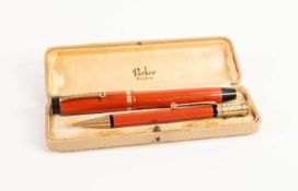 PARKER DUOFOLD LUCKY CURVE BOXED FOUNTAIN PEN AND PROPELLING PENCIL, orange, black and gilt metal,