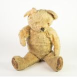 LARGE PRE-WAR GOLDEN PLUSH, PROBABLY BRITISH, TEDDY BEAR, straw filled, with swivel head and