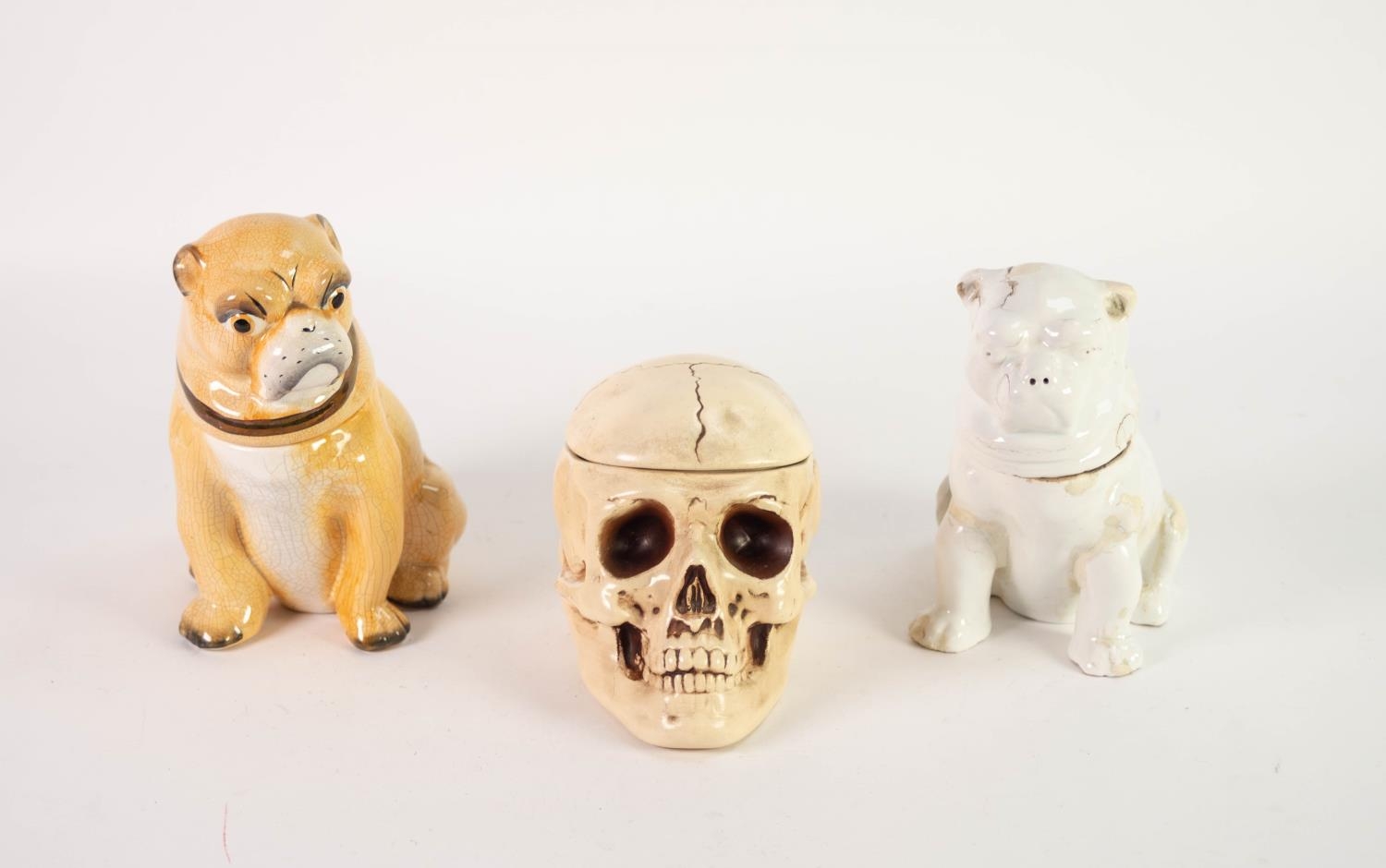 TWO POTTERY TOBACCO JARS AND COVERS MODELLED AS SEATED PUG DOGS, one white glazed, nineteenth