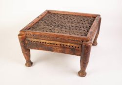 AN EARLY TWENTIETH CENTURY INDIAN SQUARE HARDWOOD STOOL, THE FRAMED PLANK TOP WITH AN ALL OVER BLIND