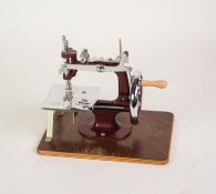 CIRCA 1960's SINGER BOXED CHILD'S 'ESSEX' CHROMIUM PLATE AND RED METAL HAND SEWING MACHINE, in