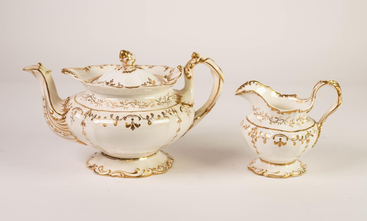 VICTORIAN STAFFORDSHIRE PORCELAIN ROCOCO REVIVAL TEAPOT AND MATCHING CREAM JUG, scroll moulded and