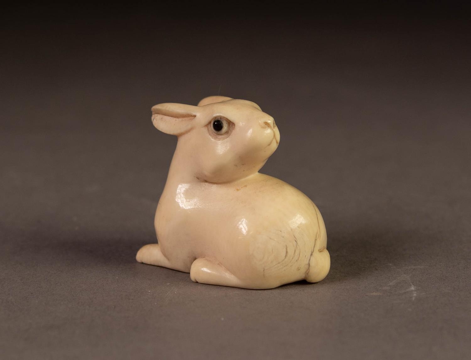 JAPANESE MEIJI PERION CARVED IVORY NETSUKE OF A RABBIT, modelled facing backwards, 1 ¼? (3.1cm)