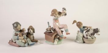 THREE LLADRO PORCELAIN GROUPS OF YOUNG CHILDREN WITH DOGS, one modelled bathing a dog, (5455),