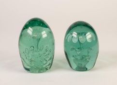 TWO VICTORIAN GREEN TINTED GLASS DUMPS or doorstops, each enclosing silvery floral tiers and one