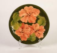 WALTER MOORCROFT HIBISCUS PATTERN TUBE LINED POTTERY PLAQUE, of typical form, painted in tones of