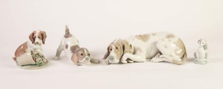FOUR LLADRO PORCELAIN MODELS OF DOGS, including a recumbent example, 10? (25.4cm) long, and