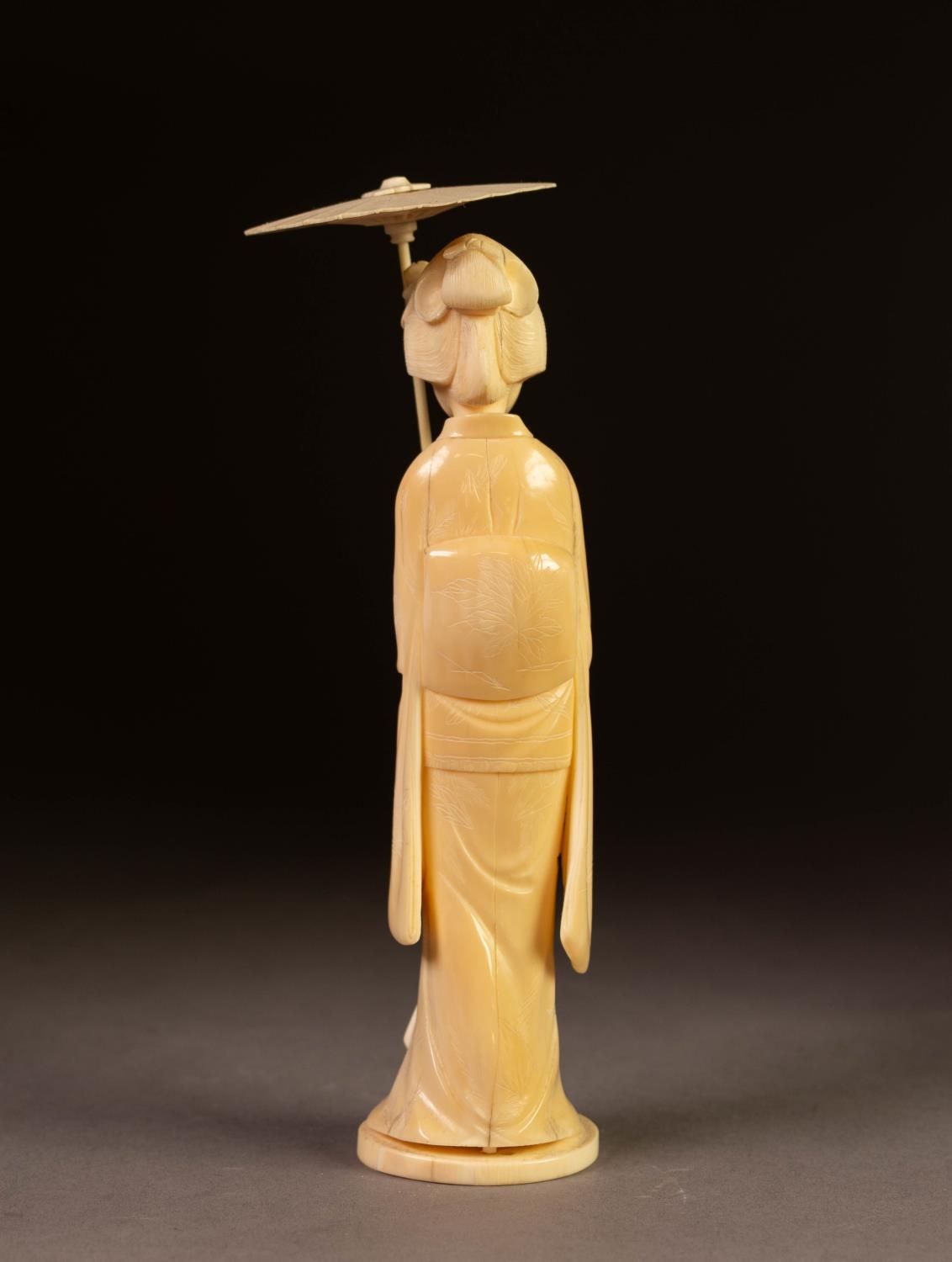 JAPANESE MEIJI PERIOD CARVED IVORY OKIMONO OF A GEISHA, modelled carrying a rose and open parasol, - Image 2 of 2