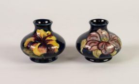 PAIR OF WALTER MOORCROFT TUBE LINED POTTERY VASES, each of squat form, one in the HIBISCUS