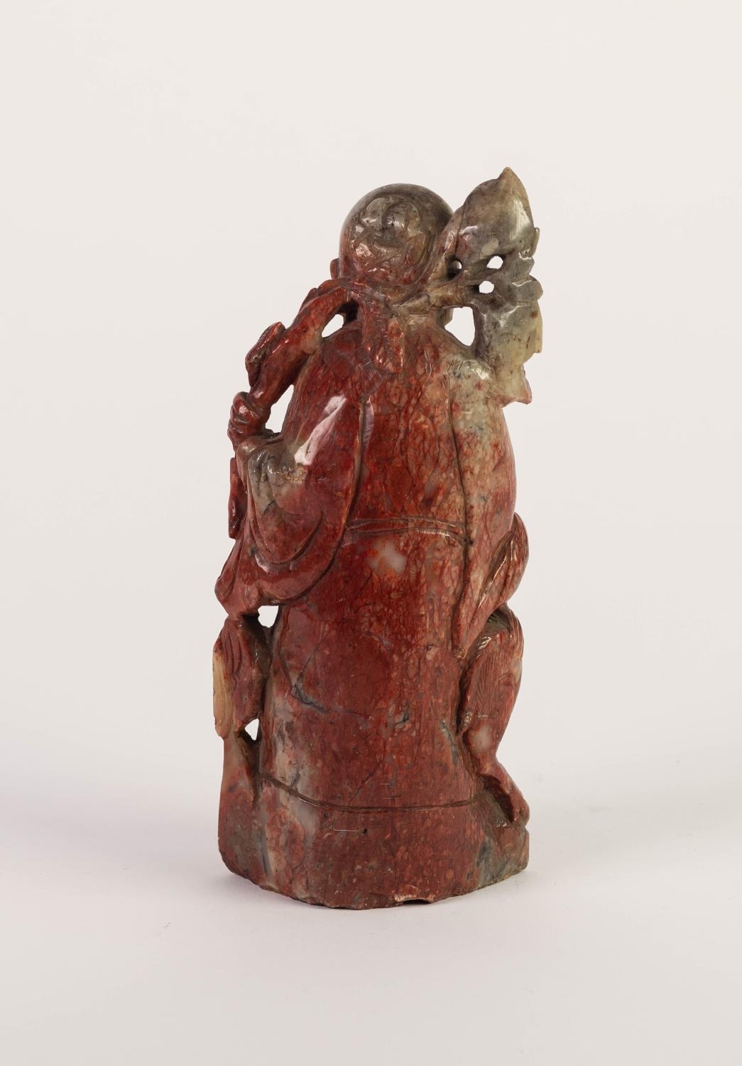 CHINESE CARVED MOTTLED RED SOAPSTONE FIGURE OF A SAGE, modelled standing with a young deer at his - Image 2 of 2