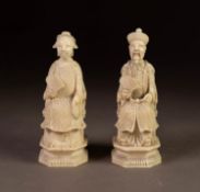 PAIR OF JAPANESE MEIJI PERIOD CARVED IVORY SEATED FIGURES, modelled as a male and female mandarin,