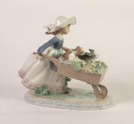 LLADRO PORCELAIN FIGURE, modelled as young girl pushing a wheel barrow containing two puppies and