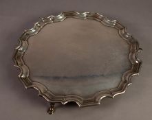 GEORGE V PRESENTATION SILVER SALVER, with moulded, wavy border, stepped pad feet and eight line