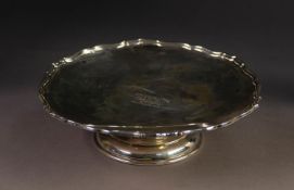 EARLY 20th CENTURY SILVER PEDESTAL CAKE STAND with moulded rim, the centre engraved with initials