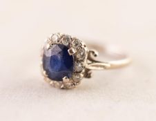 18ct GOLD RING set with a central cushion cut sapphire within a surround of twelve tiny diamonds,