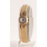 LADY'S OMEGA 9ct GOLD BRACELET WATCH with 17 jewel movement, small circular silvered dial with