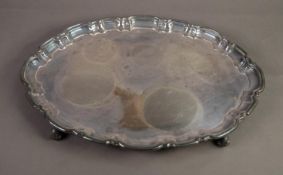 20th CENTURY SILVER GEORGIAN REVIVAL OVAL TRAY with Chippendale border, standing on four volute-