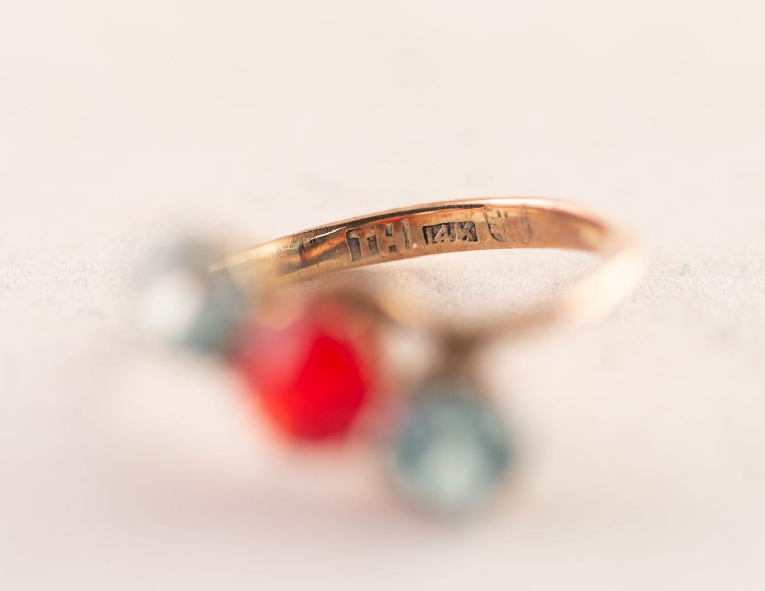 THREE STONE RED AND PALE BLUE PASTE SET CROSS-OVER RING, (stamped 14k), 2.22 gms, ring size J/K - Image 3 of 3