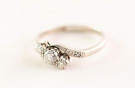 18ct WHITE GOLD AND PLATINUM CROSSOVER RING set with three round brilliant cut diamonds and a tiny