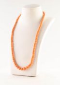 CORAL BEAD NECKLACE with 9ct white gold clasp. (In need of restringing)