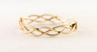 9ct GOLD HINGE-OPENING BANGLE of three strand interwoven pattern, 13.5 gms