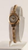 A 9ct GOLD J W BENSON, LONDON LADY'S WRISTWATCH with baton numerals, on linked bracelet, 12.3 grms