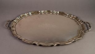 GEORGE V PRESENTATION SILVER TWO HANDLED TEA TRAY BY MAPPIN & WEBB, of oval form with moulded,