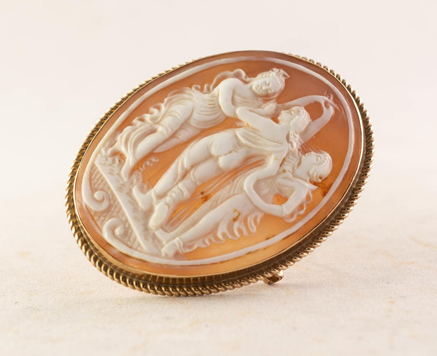 9ct GOLD FRAMED OVAL CARVED SHELL CAMEO BROOCH, depicting the Three Graces, 2 1/8in (5.3cm) high,