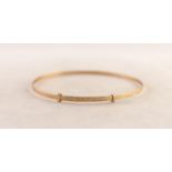 9ct GOLD NARROW BANGLE with slide expanding action, engraved decoration, Birmingham 1987, 4.7gms
