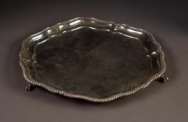 EARLY 20th CENTURY SILVER WAITER with gadrooned edged pie-crust border, on three claw feet,