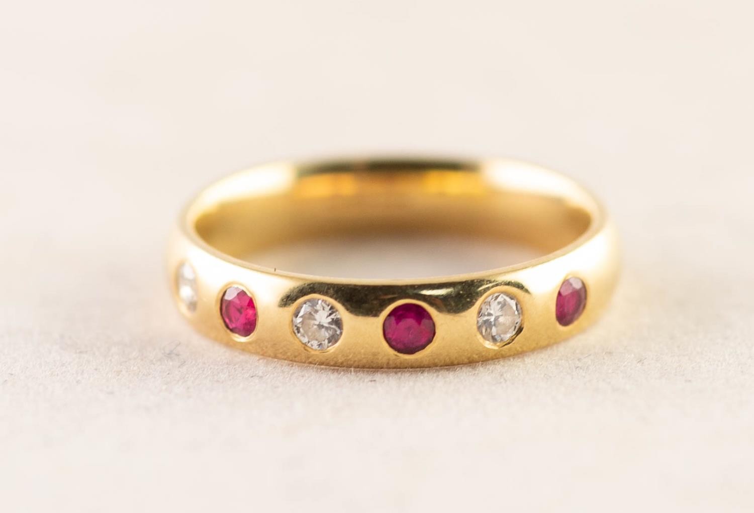 18ct GOLD BAND RING, the top gypsy set with a half hoop of three small diamonds and three uniform
