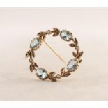 9ct GOLD CIRCLET OR WREATH PATTERN BROOCH set with four oval blue zircons and four seed pearls, 1